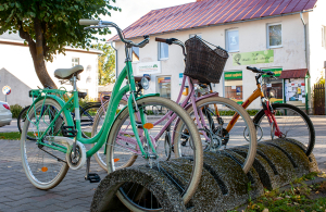 Pie veikala Top pastāvīgi stāv divi velosipēdi. Rozā pieder maiņas vadītājai, zaļais — veikala vadītājai. Pēc riteņiem var pateikt, kura no viņām ir darbā un vai veikals ir vaļā. Velosipēdi nav pieslēgti, jo nekur tālu ar tik zīmīgiem braucamajiem netikt. Visi Apē zina, kas ar tiem pārvietojas. Foto — Ieva Salmane