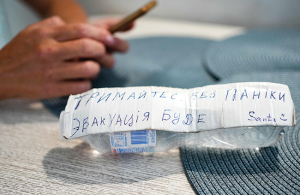 Katerina saglabājusi vienu ūdens pudeli, kas plūdu iesprostotajai sievietei un bērniem tika nomesta no drona. «Turieties, bez panikas. Evakuācija būs.» Foto — The New York Times