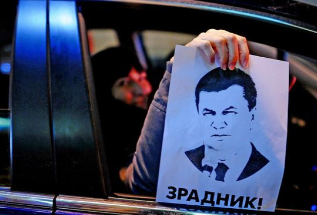 Protestētāji Kijevā rāda Ukrainas prezidenta Viktora Janukoviča portretu. Foto: ITAR-TASS/LETA