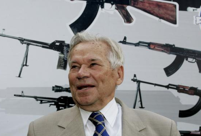 Mihails Kalašņikovs fotografēts 2007.gadā. Aiz viņa redzams leģendārais ierocis. Foto: AFP/LETA