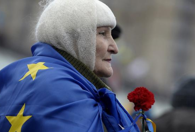Sieviete Kijevas Neatkarības laukumā ar ES karogu. Foto: EPA/LETA