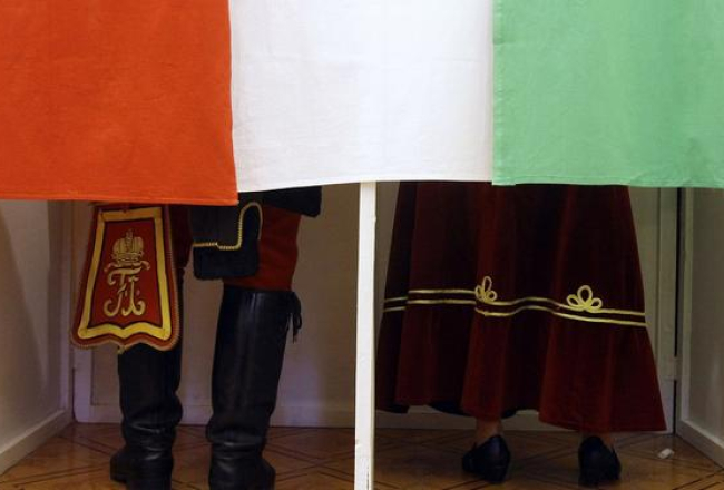 Ungāru vēlētāji tērpušies tradicionālajos ungāru huzāru tautas tērpos balso vēlēšanās. Foto: AFP/LETA