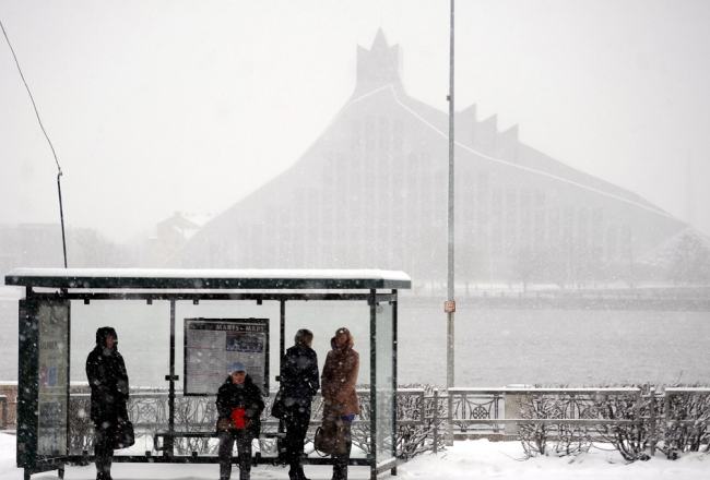 Sabiedriskā transporta pietura Rīgas centrā sniegputeņa laikā. Foto: Edijs Pālens, LETA