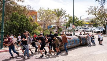 Ebreju kolonisti velk notriektās irāņu raķetes paliekas, kas nokrita pie Peduelas nometnes okupētajā Rietumkrastā.