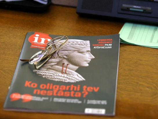Žurnāla "Ir" speciālizdevums par oligarhu lietu uz Saeimas deputāta darba galda ārkārtas sēdē, kurā lēma par parlamentārās izmeklēšanas komisijas sastāvu. Foto: Edijs Pālens, LETA