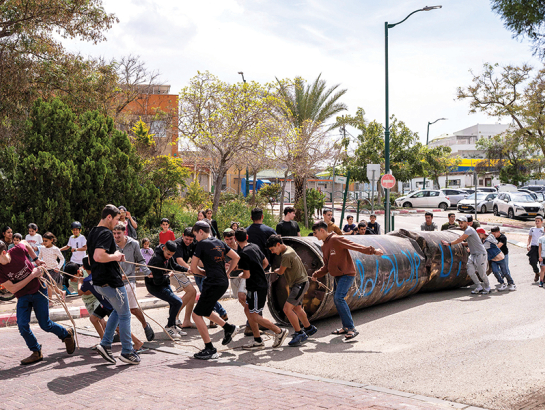 Ebreju kolonisti velk notriektās irāņu raķetes paliekas, kas nokrita pie Peduelas nometnes okupētajā Rietumkrastā.