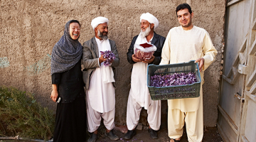 Rumi Spice līdzdibinātāja bijusī amerikāņu armijas inženiere Kimberlija Janga (pa kreisi) ar safrāna audzētājiem un pārstrādes rūpnīcas menedžeri Abdulu Šakūru Erari (pa labi).