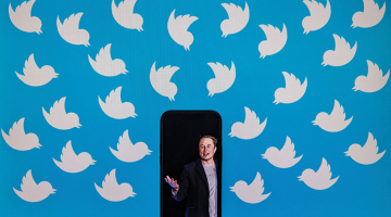 Pie datora ekrāna ar Twitter simbolu piesliets tālrunis ar Īlona Maska foto.
Foto — Scanpix
