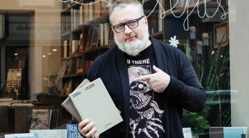 Ilmārs Šlāpins: «Man nepatīk situācijas, kad izbeidzas tirāža un es zinu, ka visdrīzāk grāmatas klāt nepiedrukās. Man ir žēl grāmatu, kuras ātri izpērk, — uz īsu brīdi ir ažiotāža, visi lasa un tad aizmirst. Man patīk, ka tās stāv veikalu plauktos vairākus gadus, turpina būt mūsu dzīvē.
Foto — Kristīne Madjare