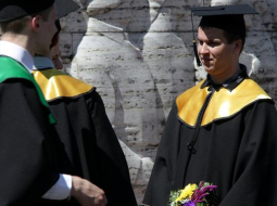 Augstskolu absolventi fotografējas pie Brīvības pieminekļa. Foto: Ieva Čīka, LETA