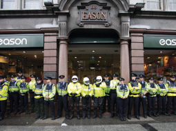 Policijas «mūris» pie grāmatnīcas Dublinā, kur 4.septembrī Tonijs Blērs ieradās uz prezentāciju un autogrāfu sniegšanu. Viņu sagaidīja aptuveni 200 protestētāji. Foto — AFP/LETA