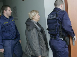 Ārija Stabiņa (centrā) policistu pavadībā tiek ievesta tiesas zālē. Foto: Raitis Plauks, F64