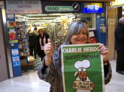 Sieviete Marseļā priecājas, ka dabūjusi "Charlie Hebdo" jaunāko numuru. Foto: AFP/LETA