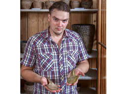 Artūrs Tomsons tur rokā divus bronzas cirvīšus, kuri zināmi kopš 19.gadsimta. Viens ir oriģināls bronzas laikmeta ierocis, otrs — 19. gadsimta pakaļdarinājums, ko var uzskatīt par vienu no pirmajiem eksperimentālās arheoloğijas paraugiem.