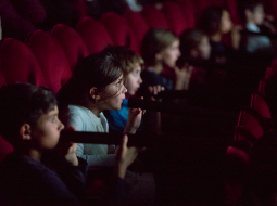 Aklais kino — skatītāji sēž kinoteātra tumsā aizsietām acīm. Katram aiz muguras atrodas bērns, kurš čukstus stāsta, kas notiek uz ekrāna.