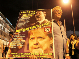Grieķijas taupības pasākumu pretinieki protestē pirms Vācijas kancleres Angelas Merkeles vizītes Atēnās. «Nepērciet vācu preces. Pretojieties Ceturtajam reiham.»
